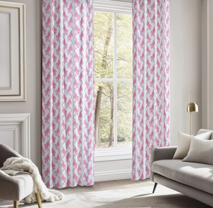 Living room with hot pink and white tiger patterned curtains.